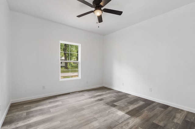 806 Iris Ave, Crane, MO 65633 - unfurnished room featuring wood finished floors, a ceiling fan, and baseboards