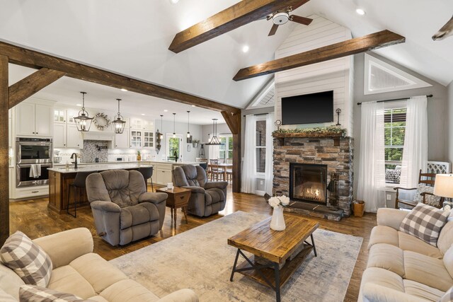 4936 S Butterfield Pl, Brookline, MO 65619 - living area featuring dark wood finished floors, ceiling fan, a stone fireplace, recessed lighting, and a chandelier