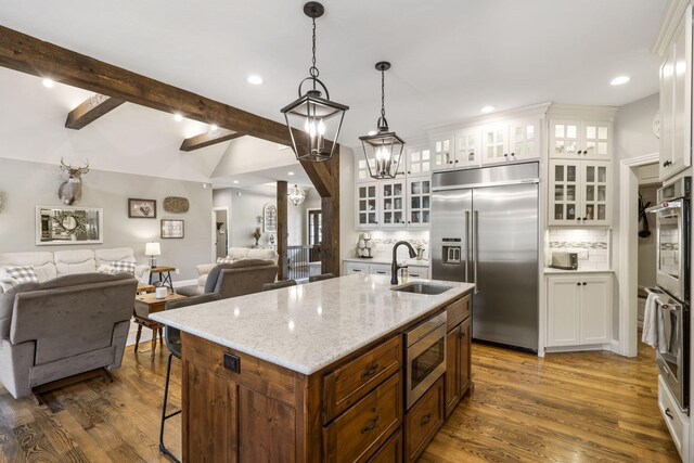 4936 S Butterfield Pl, Brookline, MO 65619 - kitchen featuring built in appliances, open floor plan, white cabinets, backsplash, and recessed lighting