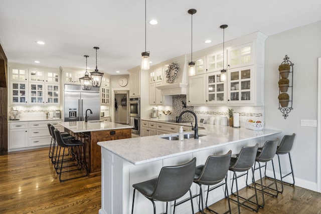 4936 S Butterfield Pl, Brookline, MO 65619 - kitchen with appliances with stainless steel finishes, a sink, backsplash, a breakfast bar area, and recessed lighting