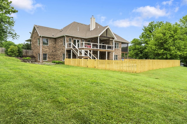 4936 S Butterfield Pl, Brookline, MO 65619 - rear view of property featuring brick siding, a chimney, stairway, and a wooden deck