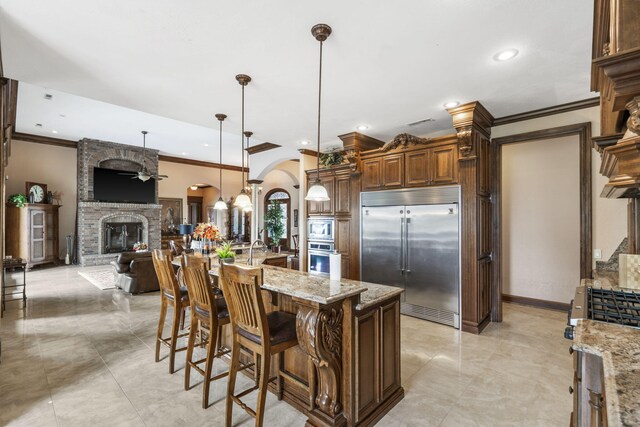 3731 S Farm Rd Unit 219, Rogersville, MO 65742 - kitchen featuring built in appliances, arched walkways, crown molding, a fireplace, and open floor plan