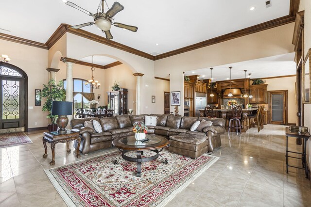 3731 S Farm Rd Unit 219, Rogersville, MO 65742 - living room featuring a chandelier, ornate columns, a ceiling fan, arched walkways, and ornamental molding