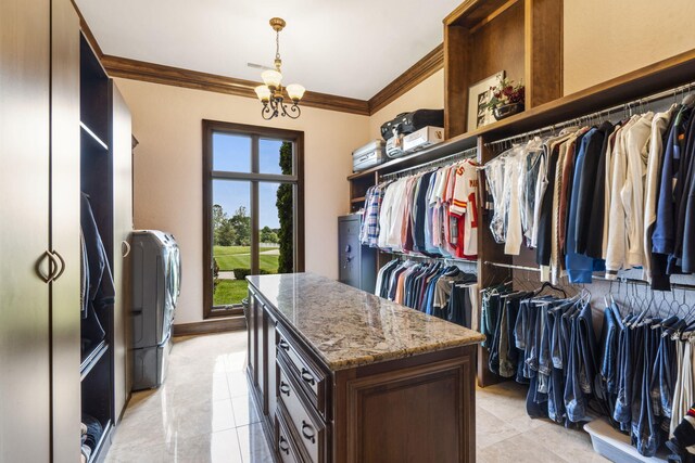 3731 S Farm Rd Unit 219, Rogersville, MO 65742 - walk in closet with light tile patterned flooring, a chandelier, and washer and dryer