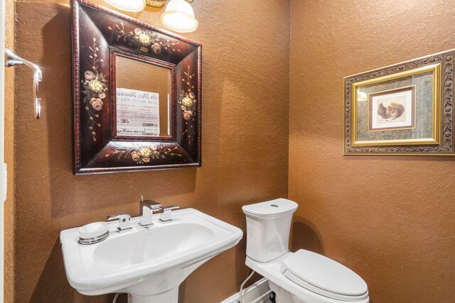 3731 S Farm Rd Unit 219, Rogersville, MO 65742 - half bath featuring a textured wall, a sink, and toilet