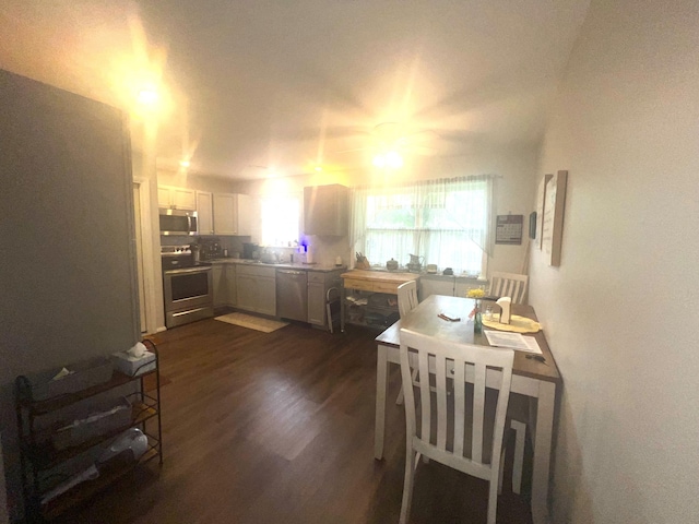 608 N Chapman St, Anderson, MO 64831 - kitchen featuring stainless steel appliances, dark wood-type flooring, light countertops, and white cabinetry