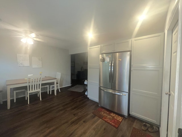 608 N Chapman St, Anderson, MO 64831 - kitchen featuring freestanding refrigerator, dark wood-type flooring, a ceiling fan, and white cabinetry