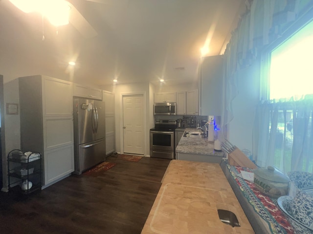 608 N Chapman St, Anderson, MO 64831 - kitchen with appliances with stainless steel finishes, a sink, dark wood finished floors, white cabinets, and ceiling fan