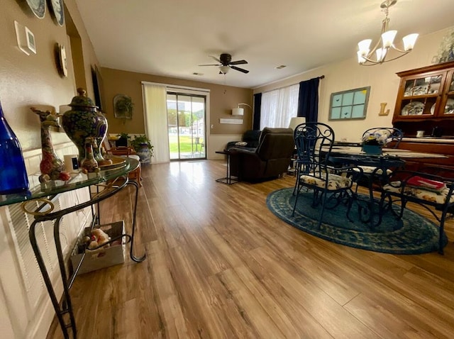123 River Point Rd Unit 33, Hollister, MO 65672 - living room featuring wood finished floors, a chandelier, and a ceiling fan