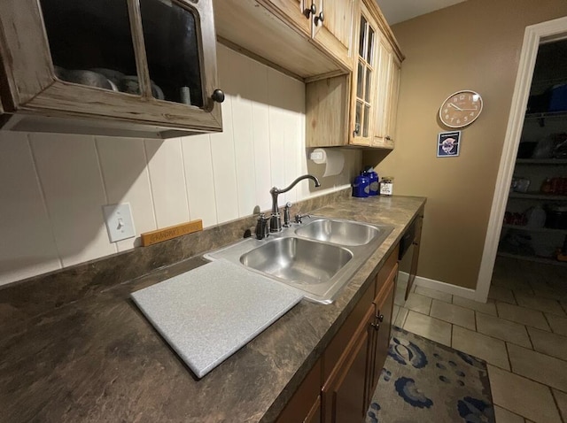 123 River Point Rd Unit 33, Hollister, MO 65672 - kitchen with a sink, glass insert cabinets, light tile patterned floors, dark countertops, and baseboards