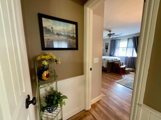 123 River Point Rd Unit 33, Hollister, MO 65672 - hall with wood finished floors, wainscoting, and a decorative wall