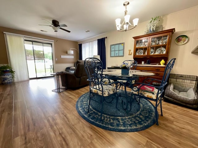123 River Point Rd Unit 33, Hollister, MO 65672 - dining space with a chandelier, wood finished floors, and ceiling fan