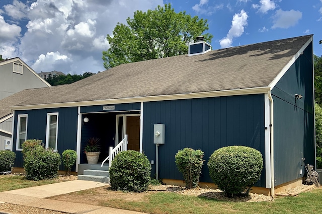 123 River Point Rd Unit 33, Hollister, MO 65672 - view of front of house with a chimney and a shingled roof