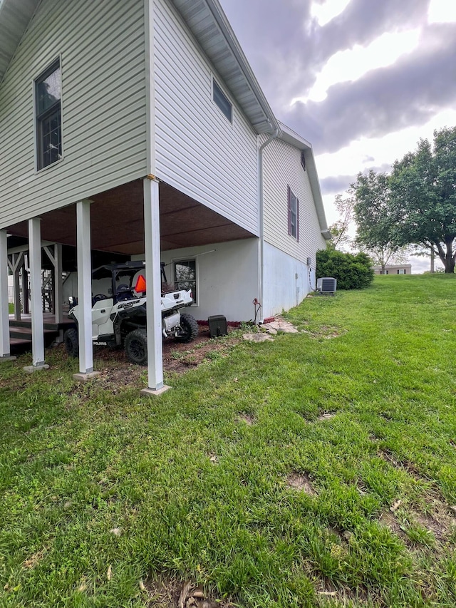 21650 Kings Loop, Hermitage, MO 65668 - view of side of property with cooling unit, a lawn, and a carport