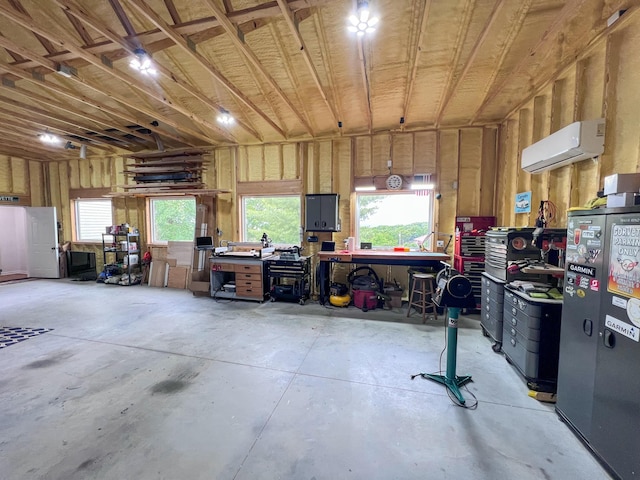 21650 Kings Loop, Hermitage, MO 65668 - garage with a workshop area and a wall mounted air conditioner