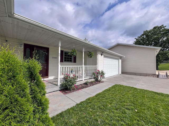 21650 Kings Loop, Hermitage, MO 65668 - view of front of home featuring a porch, a garage, concrete driveway, and a front lawn