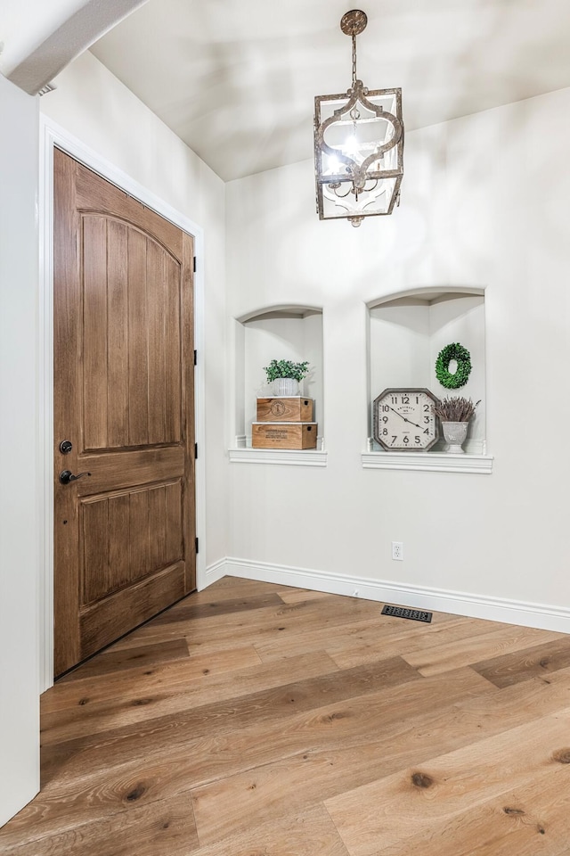 1086 S Joshua Ave, Republic, MO 65738 - entrance foyer with a chandelier, wood finished floors, and baseboards