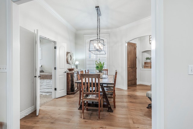 1086 S Joshua Ave, Republic, MO 65738 - dining room with a chandelier, crown molding, arched walkways, light wood-type flooring, and baseboards