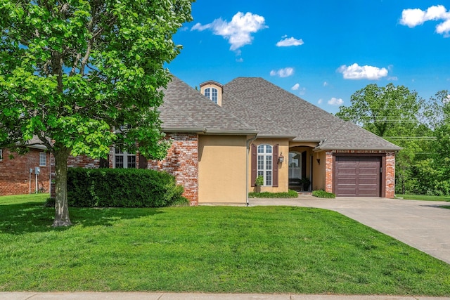 1086 S Joshua Ave, Republic, MO 65738 - french country inspired facade with a garage, driveway, a front lawn, a shingled roof, and stucco siding
