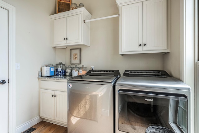 1086 S Joshua Ave, Republic, MO 65738 - laundry area featuring washer and clothes dryer, cabinet space, wood finished floors, and baseboards