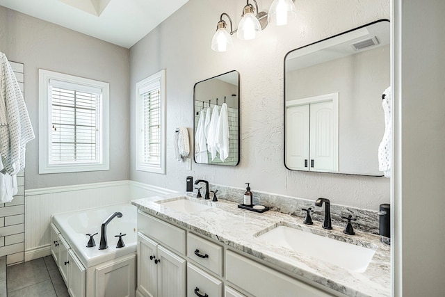 1086 S Joshua Ave, Republic, MO 65738 - bathroom with a chandelier, a bath, double vanity, tile patterned flooring, and wainscoting