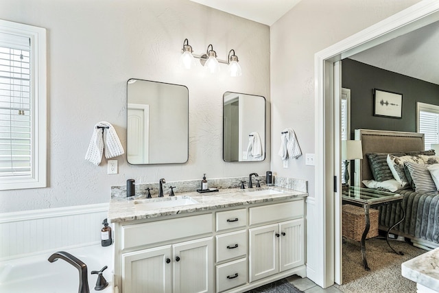 1086 S Joshua Ave, Republic, MO 65738 - ensuite bathroom with plenty of natural light, double vanity, a bath, and wainscoting
