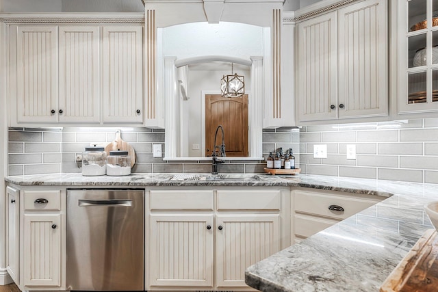 1086 S Joshua Ave, Republic, MO 65738 - kitchen featuring dishwasher, arched walkways, a sink, tasteful backsplash, and light stone countertops