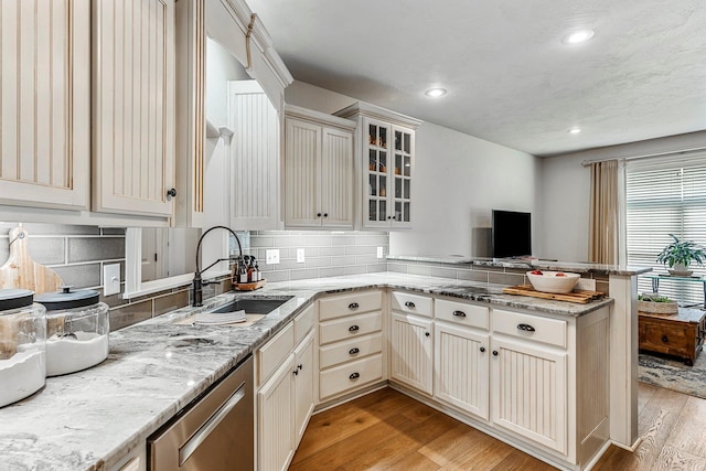 1086 S Joshua Ave, Republic, MO 65738 - kitchen with stainless steel dishwasher, a sink, a peninsula, light wood-type flooring, and light stone countertops