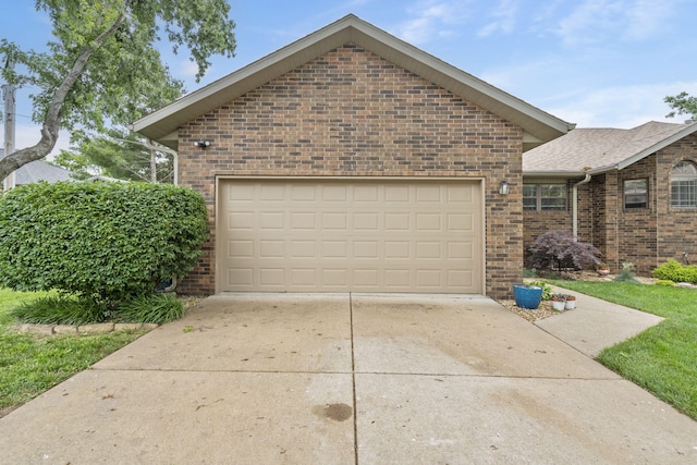 650 S Woodbridge Ct, Nixa, MO 65714 - view of front facade with brick siding, concrete driveway, and an attached garage
