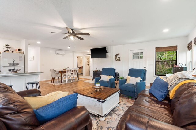 96 Samson St, Cape Fair, MO 65624 - living area with a wall mounted air conditioner, a ceiling fan, recessed lighting, baseboards, and light wood-style flooring