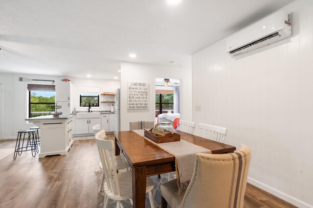 96 Samson St, Cape Fair, MO 65624 - dining space with an AC wall unit, light wood-style floors, healthy amount of natural light, a ceiling fan, and recessed lighting