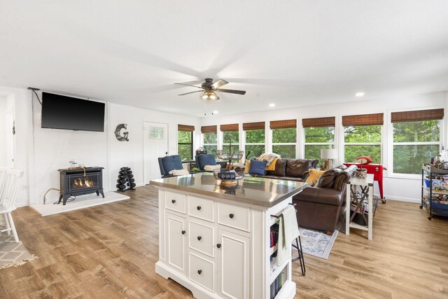 96 Samson St, Cape Fair, MO 65624 - kitchen featuring open floor plan, a ceiling fan, white cabinetry, a center island, and light wood-style floors