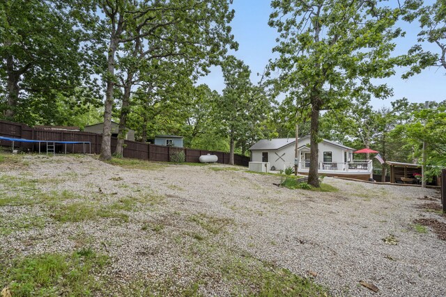 96 Samson St, Cape Fair, MO 65624 - view of yard with a trampoline, a wooden deck, and view of scattered trees