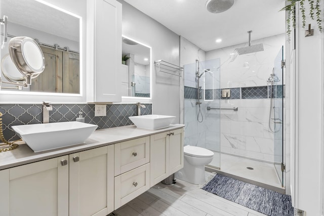 1514 W Swan St, Springfield, MO 65807 - full bathroom with a marble finish shower, double vanity, toilet, wood finished floors, and recessed lighting