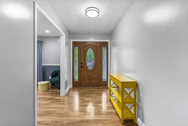 1514 W Swan St, Springfield, MO 65807 - foyer entrance featuring light wood-style flooring, baseboards, and a textured ceiling