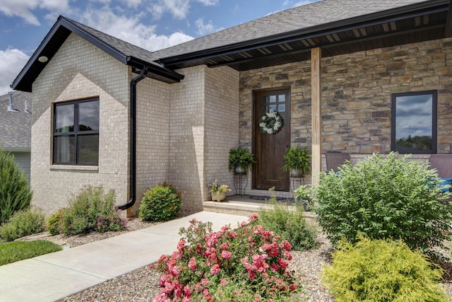 1503 W Ragweed Ct, Ozark, MO 65721 - property entrance with roof with shingles, stone siding, brick siding, and covered porch