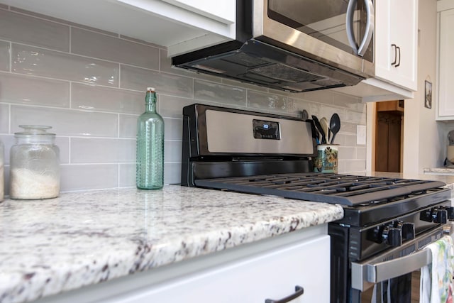 1503 W Ragweed Ct, Ozark, MO 65721 - kitchen featuring stainless steel appliances, tasteful backsplash, white cabinets, and light stone counters