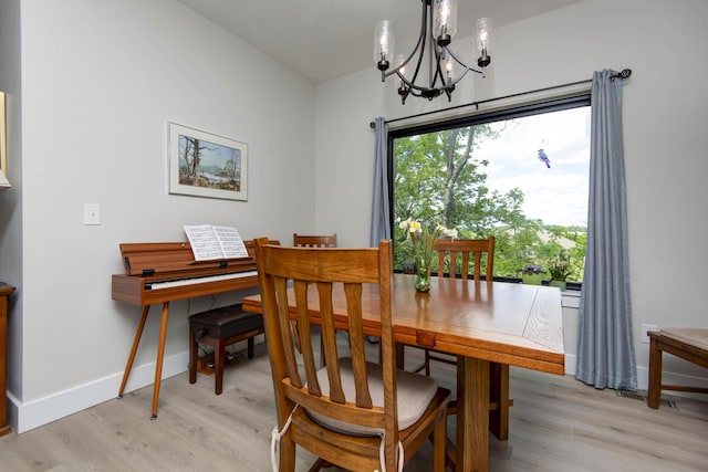 1503 W Ragweed Ct, Ozark, MO 65721 - dining area with a chandelier, light wood finished floors, and baseboards