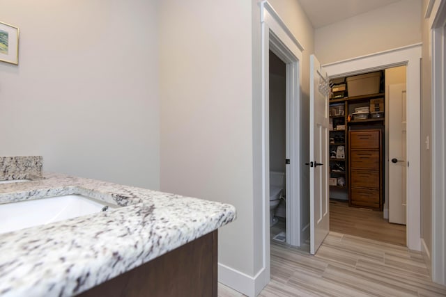 1503 W Ragweed Ct, Ozark, MO 65721 - bathroom with toilet, baseboards, vanity, and wood finished floors