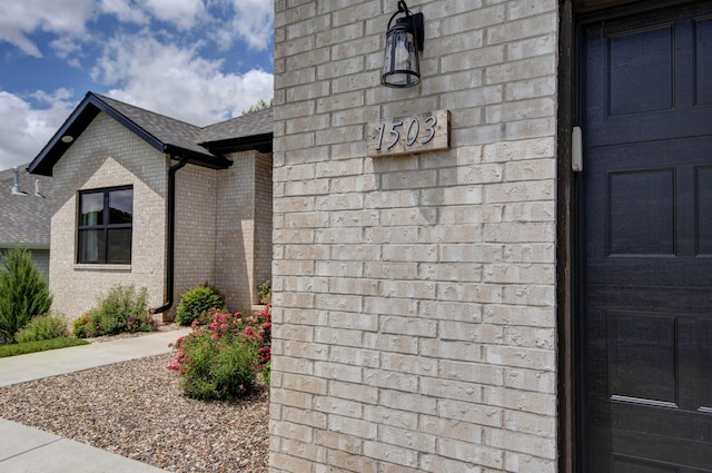1503 W Ragweed Ct, Ozark, MO 65721 - view of home's exterior with brick siding and a shingled roof