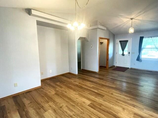 607 Robin Rd, Mountain Grove, MO 65711 - unfurnished dining area featuring wood finished floors, a chandelier, arched walkways, and baseboards