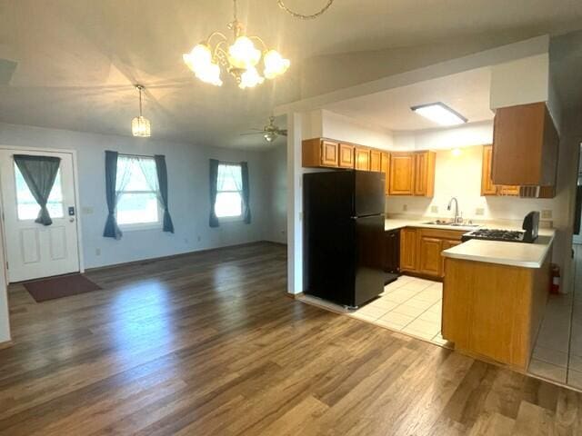 607 Robin Rd, Mountain Grove, MO 65711 - kitchen featuring freestanding refrigerator, a sink, light wood-style floors, open floor plan, and light countertops