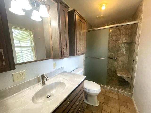 607 Robin Rd, Mountain Grove, MO 65711 - full bathroom with toilet, a shower stall, vanity, tile patterned flooring, and a chandelier