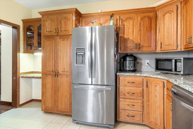 898 Short State Highway Y, Marshfield, MO 65706 - kitchen with stainless steel appliances, brown cabinetry, light stone counters, and glass insert cabinets