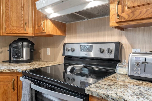 898 Short State Highway Y, Marshfield, MO 65706 - kitchen with stainless steel electric range oven, under cabinet range hood, brown cabinets, and decorative backsplash