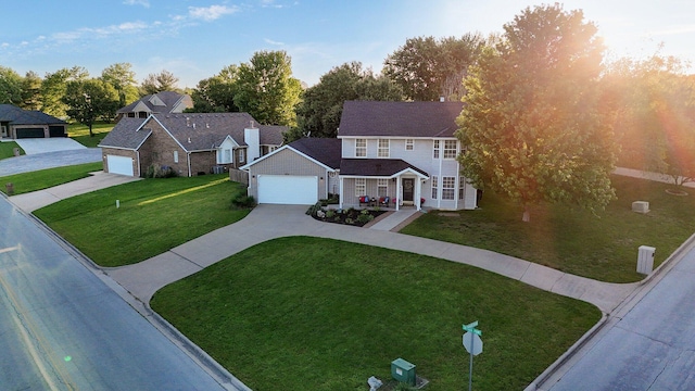 505 Thunderbird Dr, Rogersville, MO 65742 - view of front of home featuring concrete driveway, a front yard, covered porch, and a garage