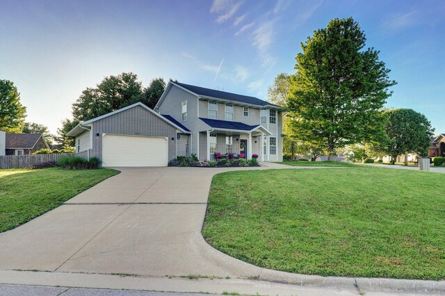 505 Thunderbird Dr, Rogersville, MO 65742 - view of front of home featuring concrete driveway, an attached garage, and covered porch