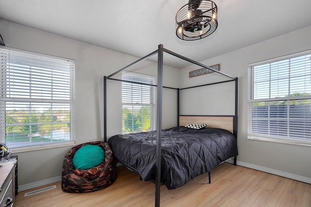 505 Thunderbird Dr, Rogersville, MO 65742 - bedroom featuring light wood-type flooring, multiple windows, and baseboards