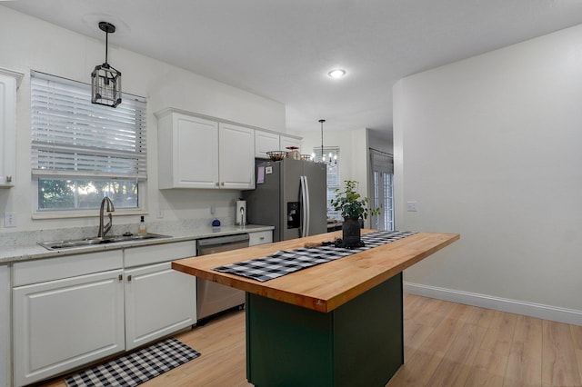 505 Thunderbird Dr, Rogersville, MO 65742 - kitchen featuring appliances with stainless steel finishes, butcher block counters, a sink, white cabinetry, and light wood-style flooring