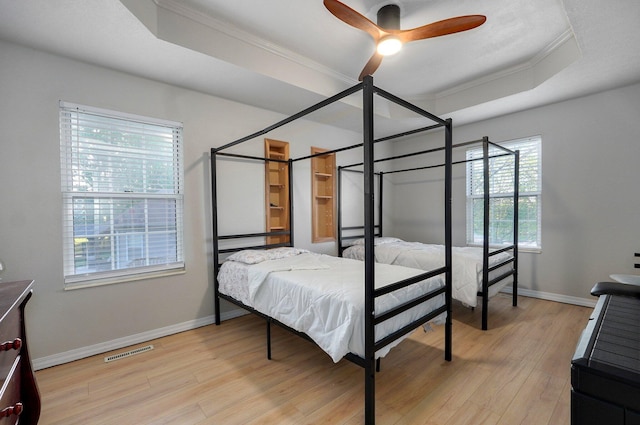 505 Thunderbird Dr, Rogersville, MO 65742 - bedroom featuring ornamental molding, a tray ceiling, baseboards, light wood finished floors, and a ceiling fan